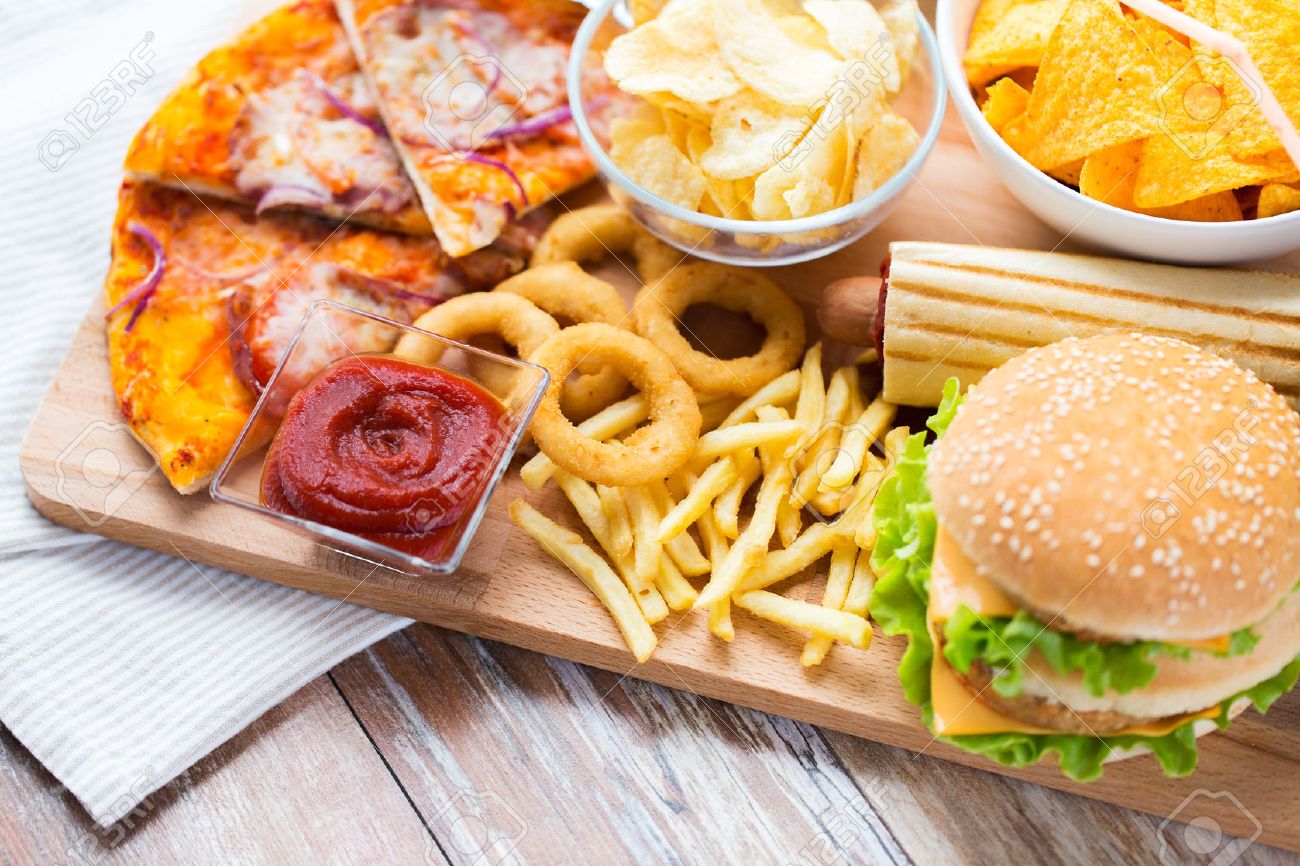 48507384-fast-food-and-unhealthy-eating-concept-close-up-of-hamburger-or-cheeseburger-deep-fried-squid-rings-.jpg